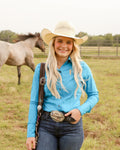 Cowgirl in a fitted mint teal button up rodeo shirt