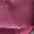 A close-up of a pink satin-like fabric 