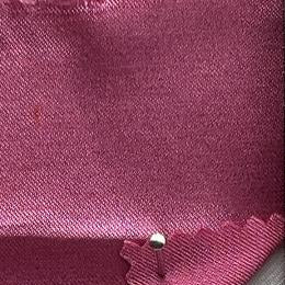A close-up of a pink satin-like fabric 