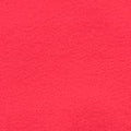 A close-up of a bright pink fabric swatch with a small white circular label reading '25' and a metal ruler along the right edge for scale.