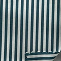 A close-up of striped fabric with dark green and white vertical stripes, shown with a white ruler on the right side for scale.